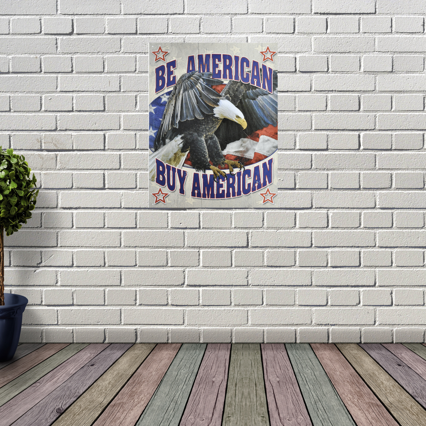 Vintage Poster Print that says " Be American, Buy American" with a bald eagle flying in the middle. With Red white and blue American flag in the background. On wall for scale.