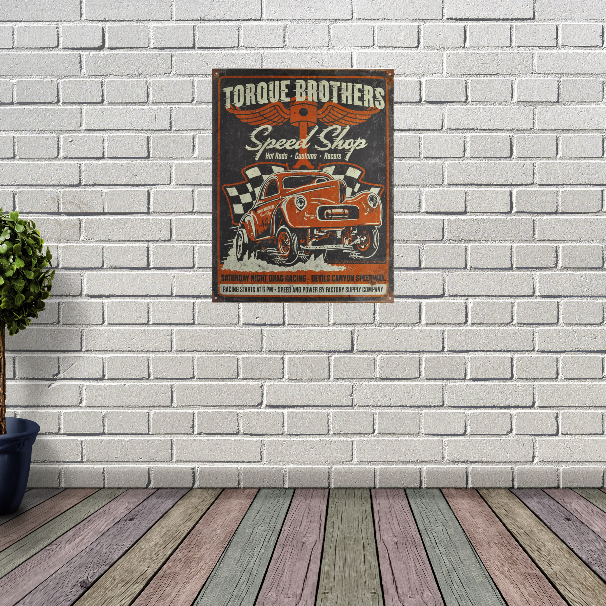 Vintage Poster Print that says "Torque Brothers Speed Shop" and a classic car in front in orange with a distressed design. on a wall for scale