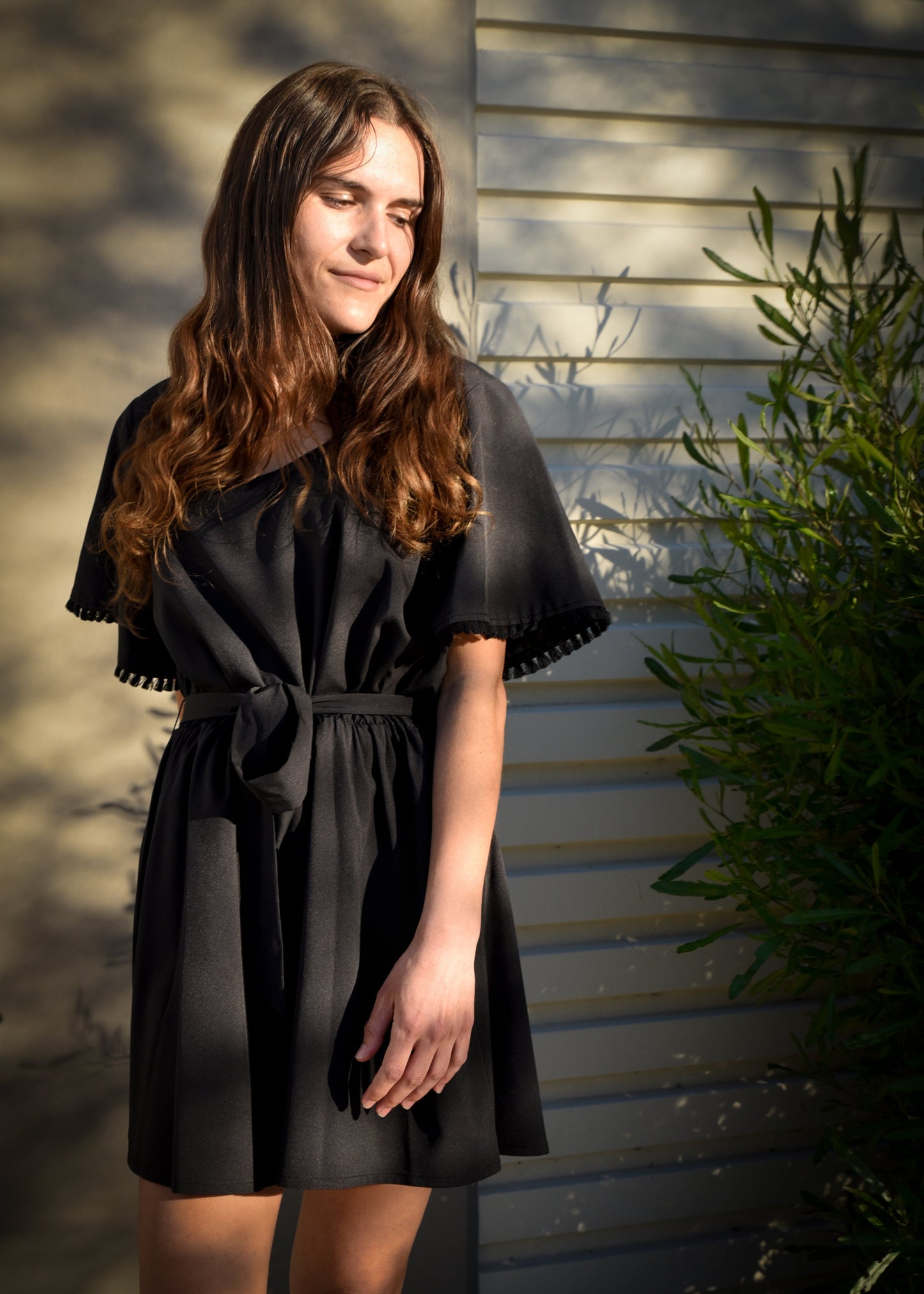 Young women wearing Young USA Casual Spring Romper with front tie in Black color.