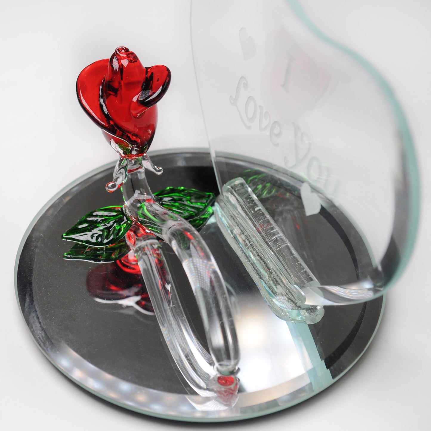 Crystal Castle Heart Shaped Glass plaque with glass rose and showcasing mirror base. The words " I love you" are engraved on the glass heart.