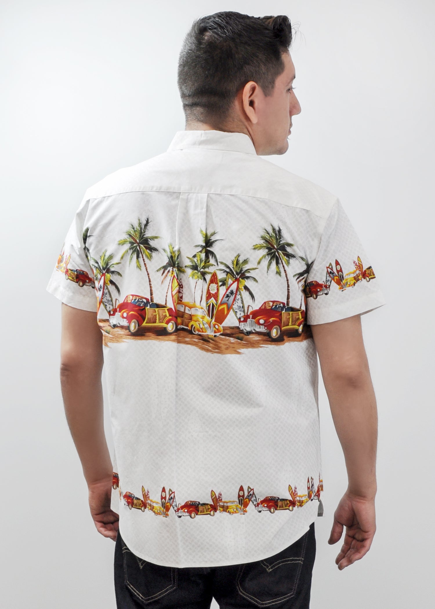Model wearing High Surf Men's Hawaiian Shirt depicting Palm Trees, Cars and Surfboards in White. Back View.
