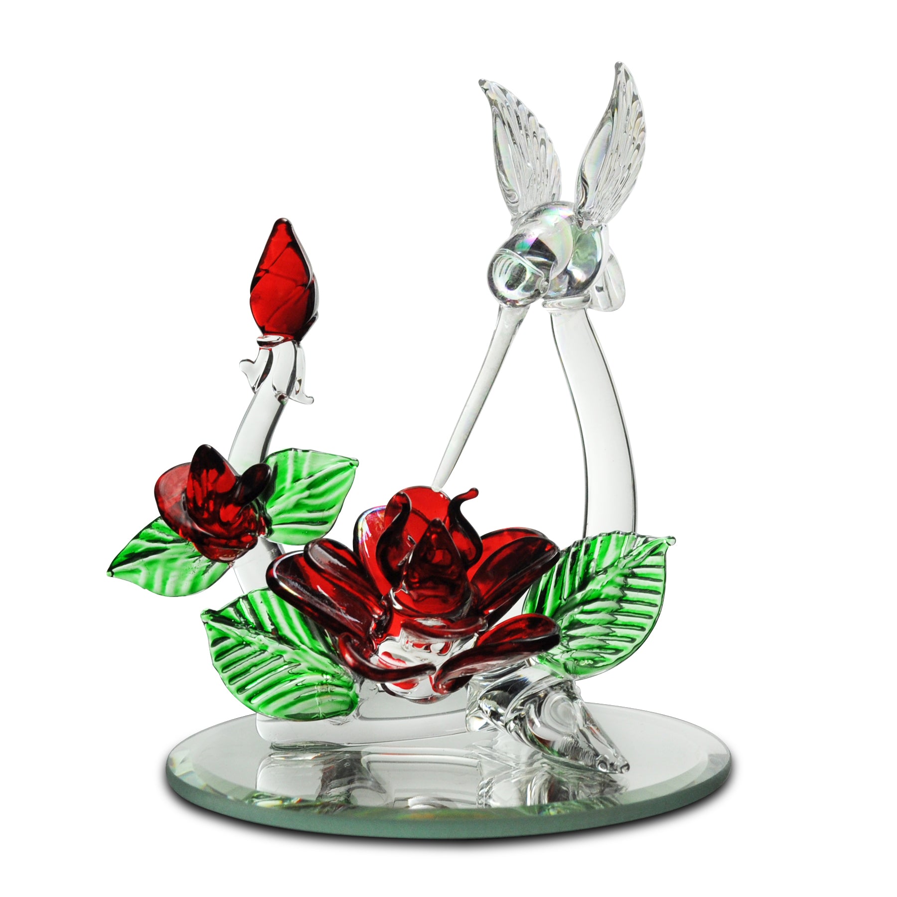 Crystal Castle Hummingbird flying over red and green glass flowers and flowers buds on a mirror base.
